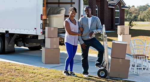 couple stands in front of moving truck